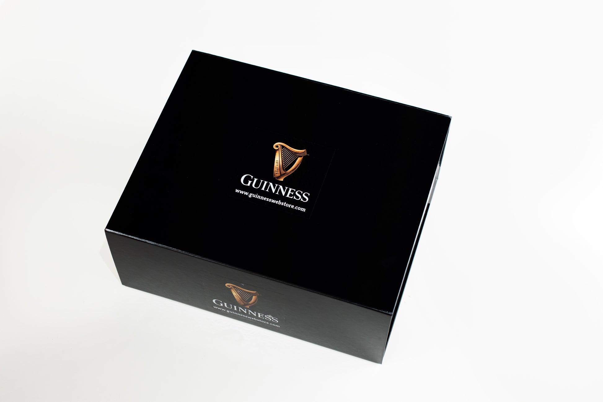 A large, black, rectangular collector's edition box from Guinness featuring the elegant Guinness logo and website printed on the lid.