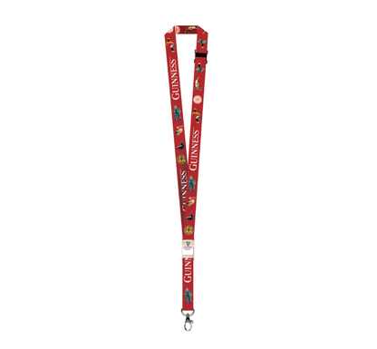 This Guinness Gilroy Lanyard Red by Guinness US showcases the iconic brand text alongside delightful penguin illustrations, finished with a durable metal clip, capturing the spirit of the cherished Irish brand.