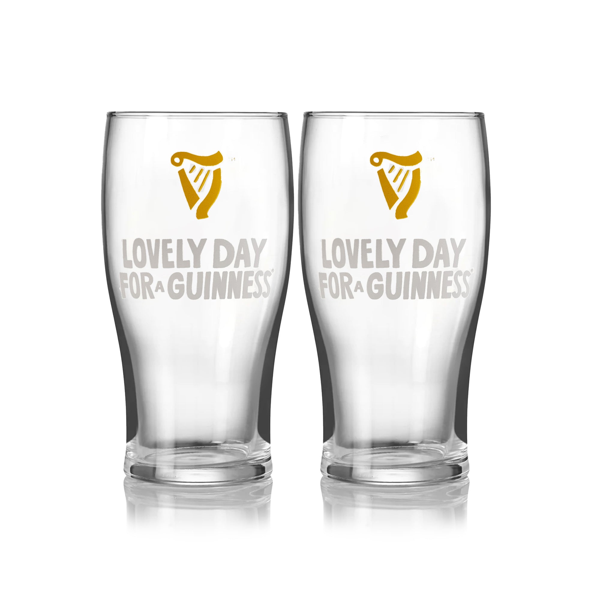 The Guinness Seb Curi Lovely Day Pint Glass 2 Pack from Guinness Webstore US features two collector’s edition pint glasses with the harp logo and "Lovely Day for a Guinness," inspired by Sebastian Curi, shown side by side on a white background.