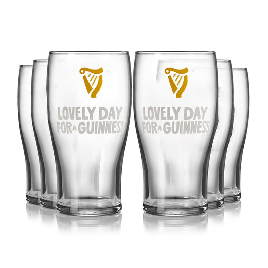 The Guinness Seb Curi Lovely Day Pint Glass - 6 Pack from Guinness Webstore US features six pint glasses with the iconic logo and "Lovely Day for a Guinness"—an ideal collector’s set for any fan.