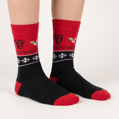 Guinness Harp & Holly Holiday Socks in black and red with harp icons, holly berries, and snowflakes.