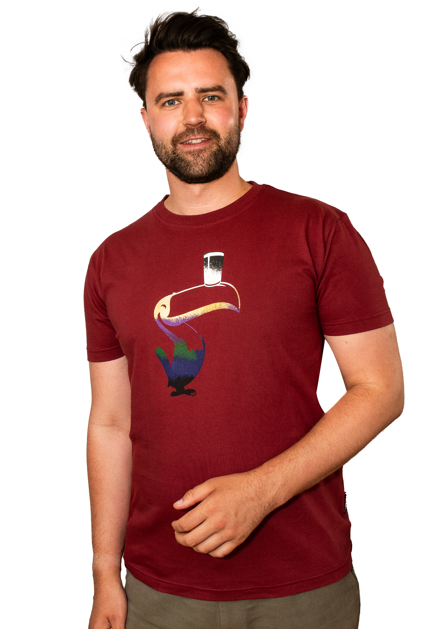 A man wearing a Guinness Liquid Toucan Tee - Red with a bird on it.