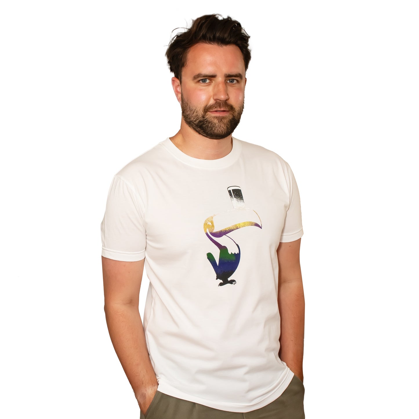 Man wearing a white Guinness Liquid Toucan Tee, standing against a white background, looking slightly to the side.
