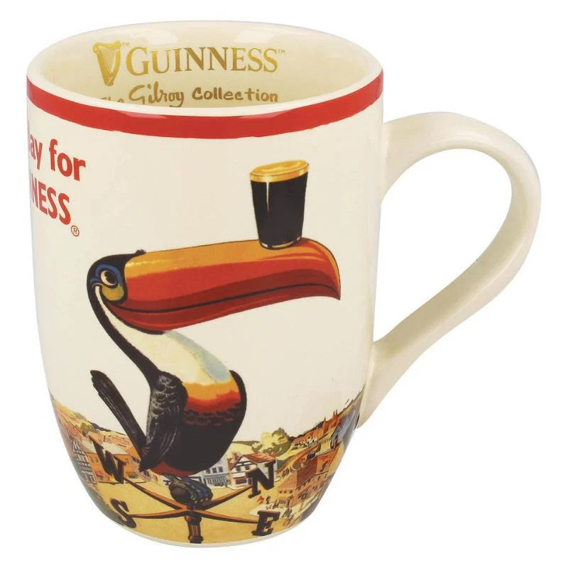 Introducing the perfect Guinness gift: the Guinness Gilroy Tulip Mug. This ceramic mug features a vintage ad design with a toucan expertly balancing a pint of beer on its beak alongside an elegant compass, making it ideal for any enthusiast of classic brewing artistry.