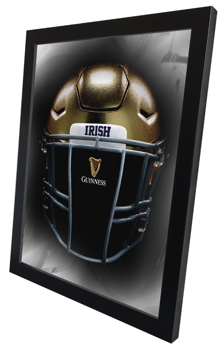 A framed officially licensed Irish football helmet, the Guinness Notre Dame Helmet Wall Mirror - 26"x15", proudly showcases Irish pride on a wall.