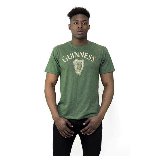 A man wearing a Guinness Vintage Harp Tee with the iconic Harp logo.