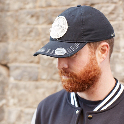 Back view of the Guinness Gaelic Bottle Opener Cap, featuring white embroidery of the number "1759" and an adjustable strap.