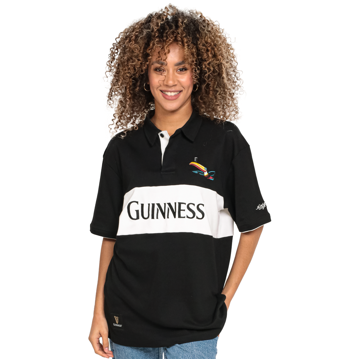 A woman wearing a Guinness Black and White Toucan Short Sleeve Rugby T-Shirt.