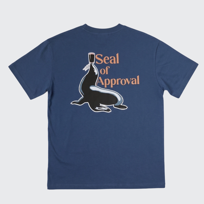 Introducing the Guinness Gilroy Seal Tee – Blue from Guinness Webstore US. This limited edition navy blue T-shirt showcases a playful graphic of a seal balancing a cup, along with the text “Seal of Approval” on the back—drawing inspiration from the iconic Gilroy collection. Perfect for fans who appreciate classic design with a fun twist.