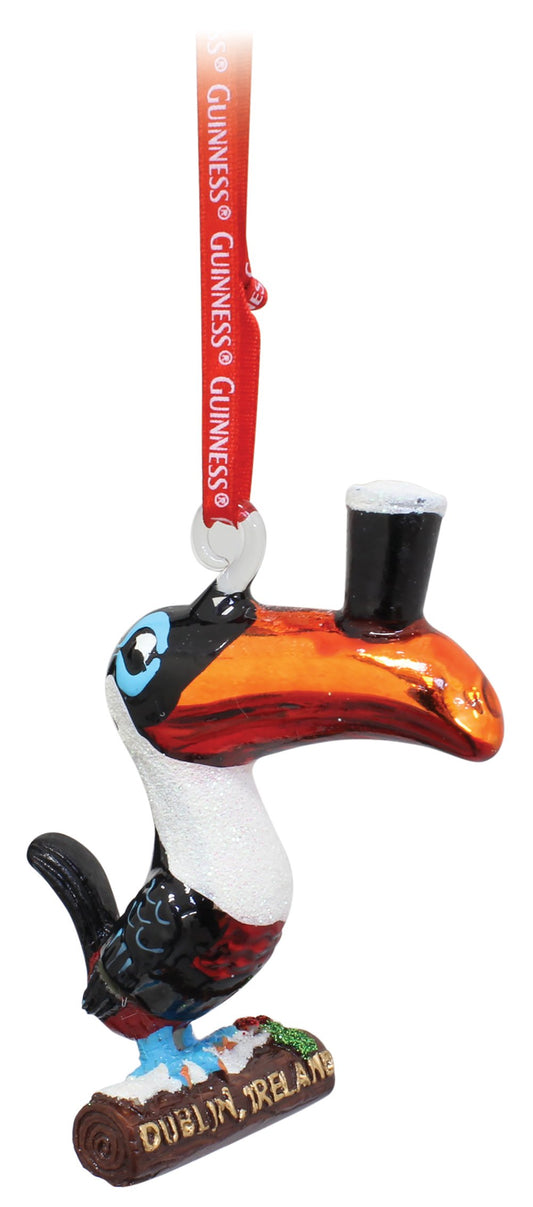 A Guinness® toucan hanging decoration with a top hat on it.