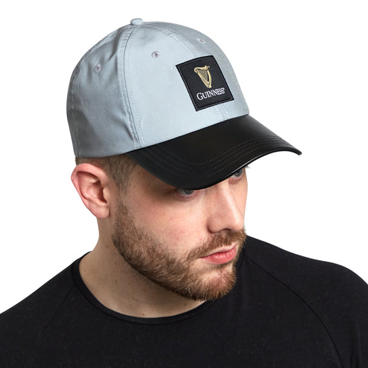 A Guinness fan wearing a Guinness Reflective Cap, with an adjustable size and a Guinness logo on it.