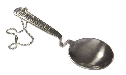 A Guinness engraved pouring spoon with a chain attached to it.