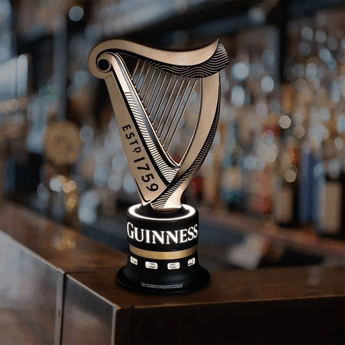A Guinness Universal USB Bar Charger, a piece of memorabilia, is sitting on top of a bar.