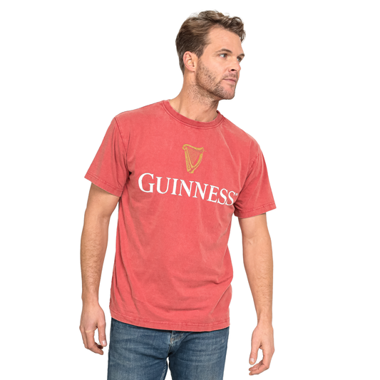 A man wearing a Red Guinness PREMIUM HARP RED TEE.