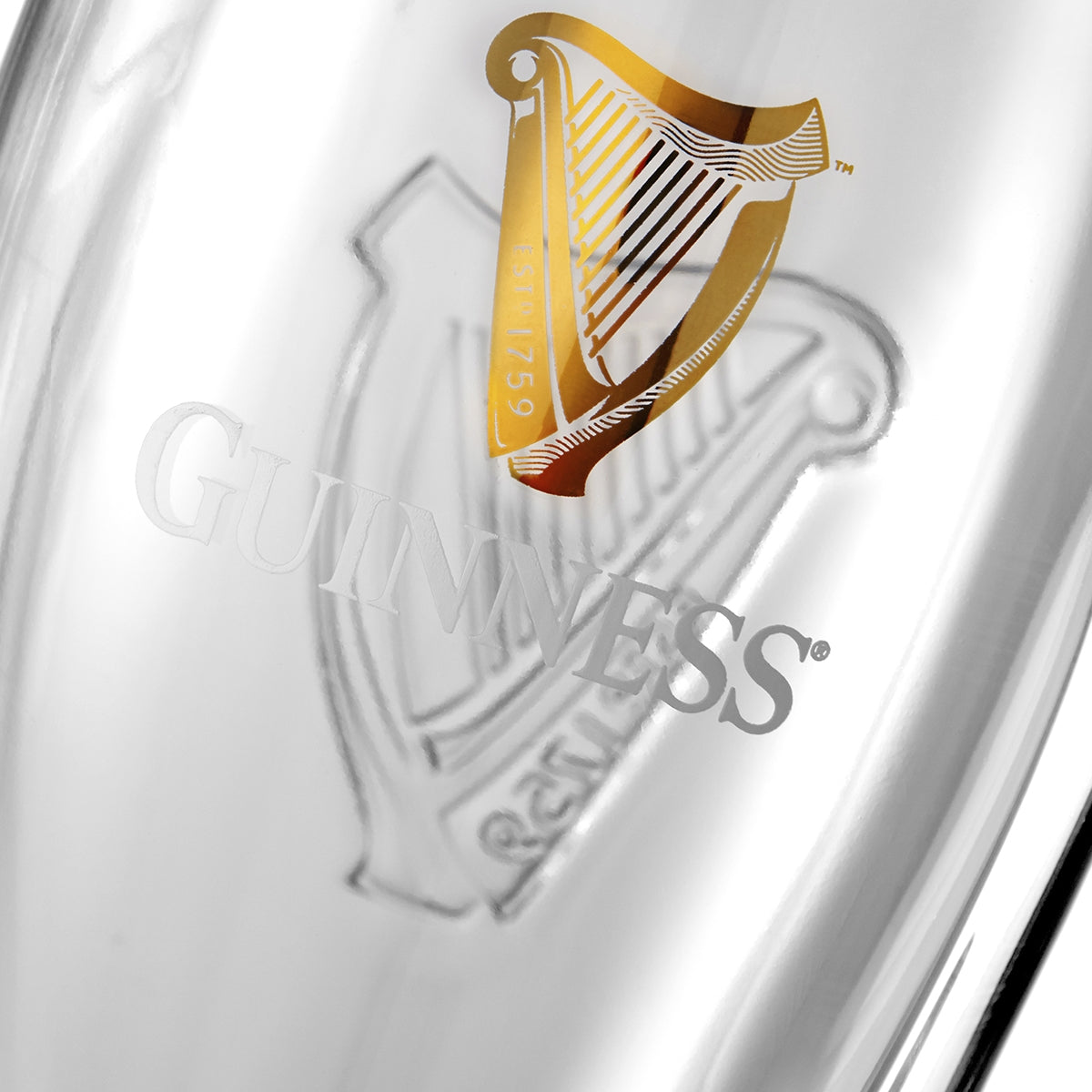Close-up of a Guinness® Pint Glass with Gift Box, featuring an etched logo and a gold-colored harp emblem.