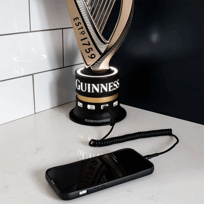A Guinness Universal USB Bar Charger with a USB charger next to it.
