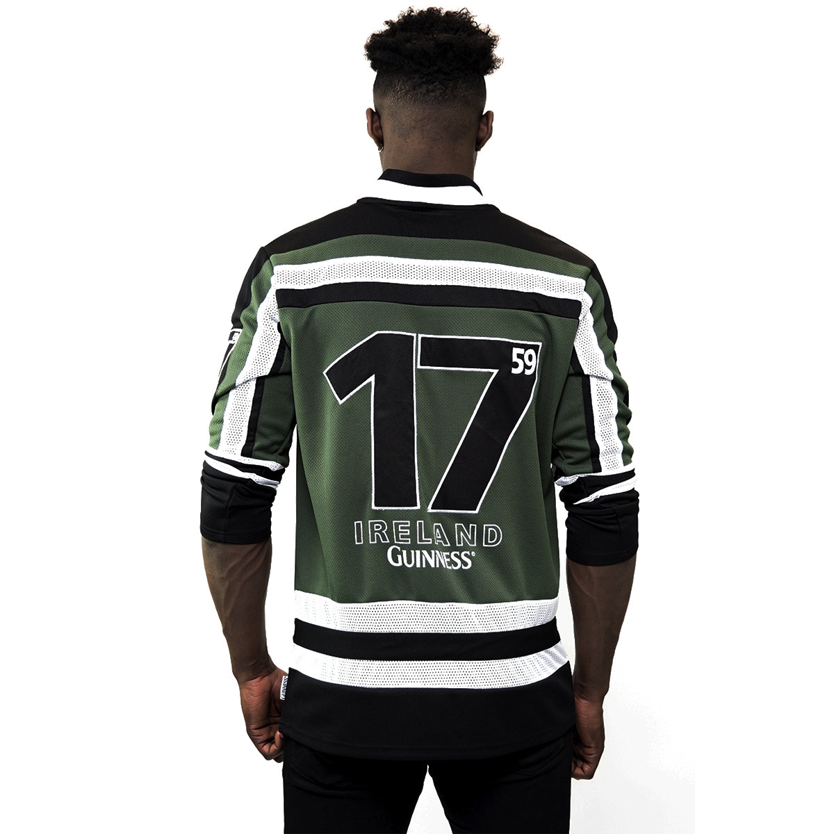 A man wearing a Guinness Green & White Hockey Jersey with the number 17 on it.
