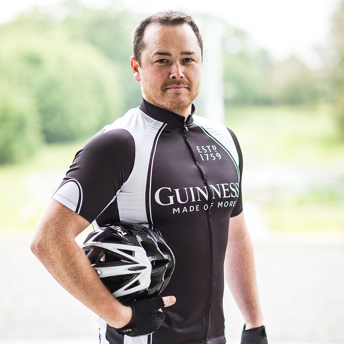 A performance-driven man holding a Guinness Basic Cycling Jersey.