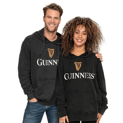 Two individuals clad in Guinness Premium Harp Hoodies from the Guinness Webstore US, crafted from mid-weight brushed cotton jersey, stand side by side and smile against a plain white background.