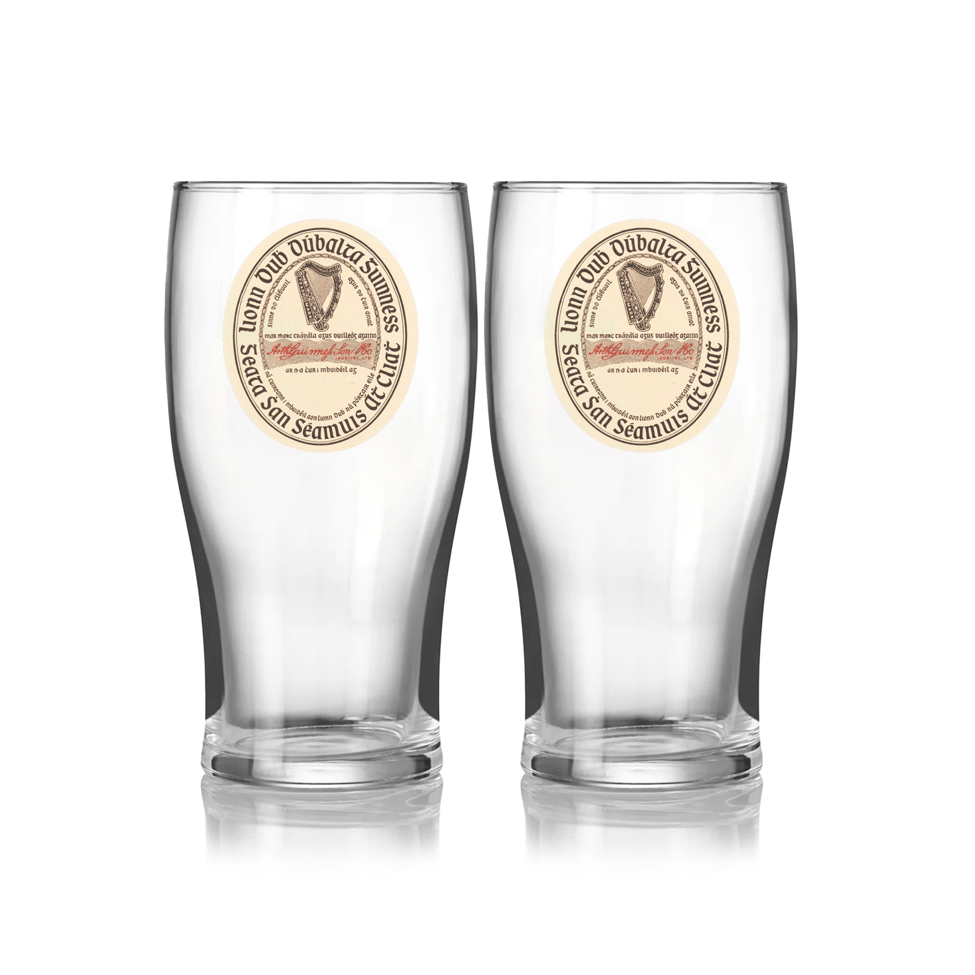 The Guinness Webstore US Guinness Vintage Label Pint Glass - 2 Pack includes two clear pint glasses with matching round vintage label designs, featuring “St. James’s Gate Dublin Extra Stout,” text, and an illustration on the front.
