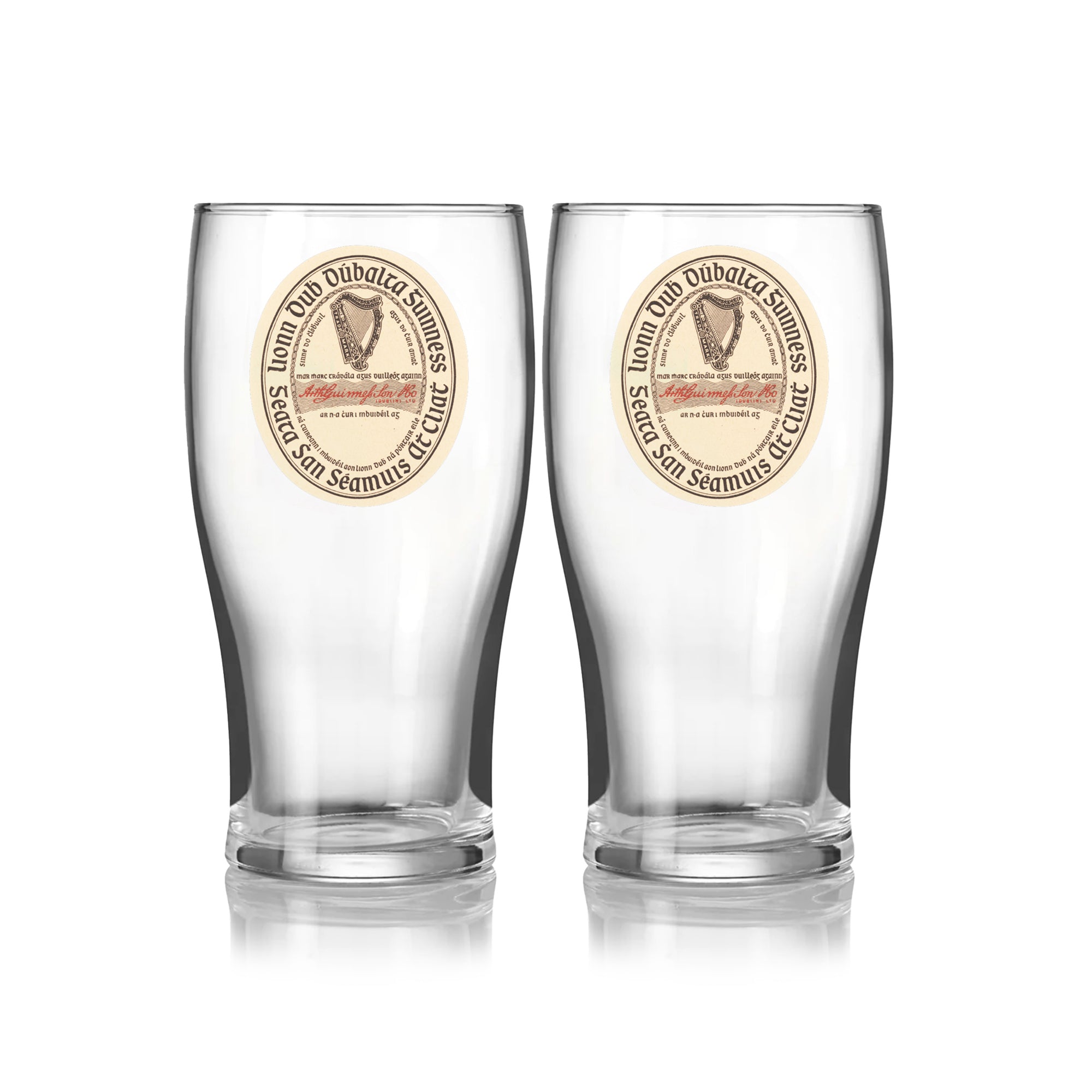 The Guinness Webstore US Guinness Vintage Label Pint Glass - 2 Pack includes two clear pint glasses with matching round vintage label designs, featuring “St. James’s Gate Dublin Extra Stout,” text, and an illustration on the front.