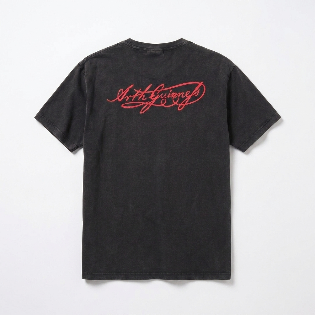 Guinness Black Distressed Label Tee by Guinness displayed flat on a plain white background, featuring red cursive text on the upper back. This unisex graphic tee combines timeless style with everyday comfort.