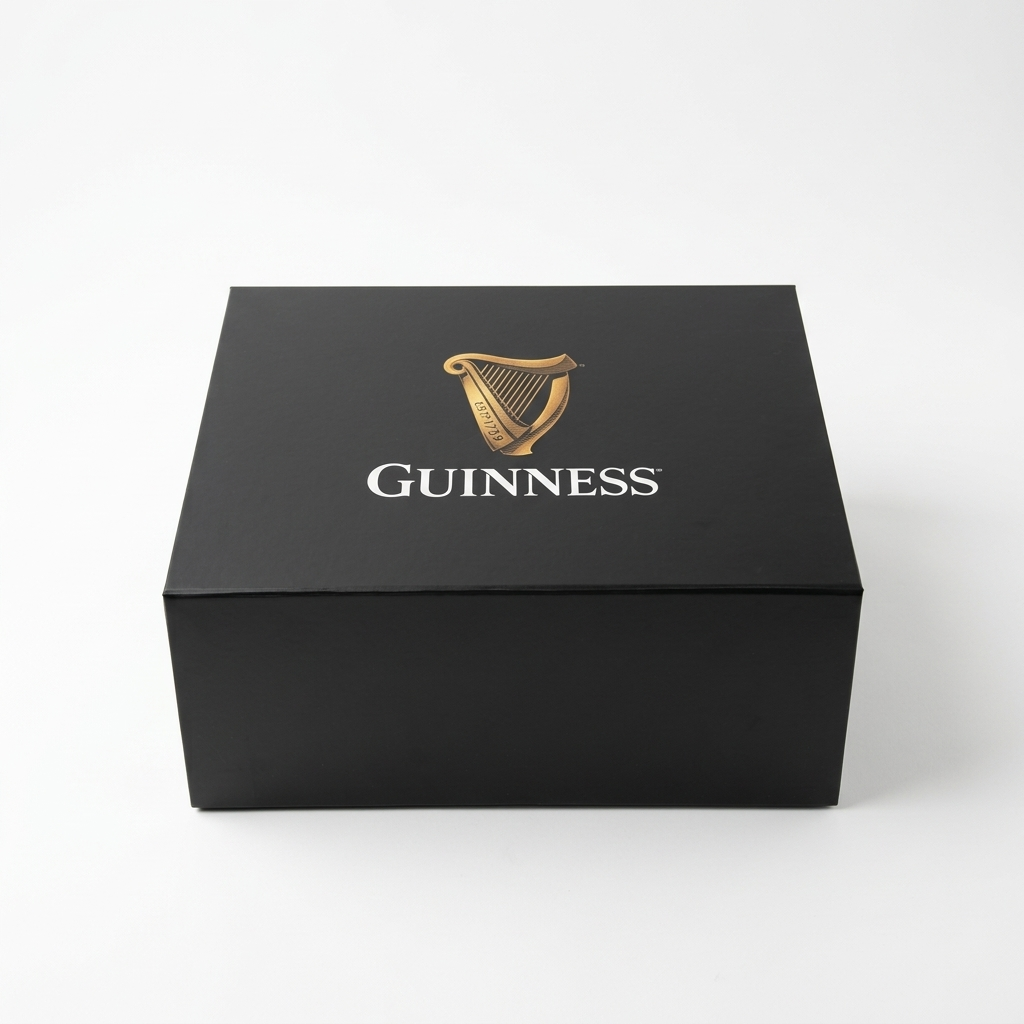 A square black Guinness Gift Box - Large featuring a gold harp logo and white text on the lid.