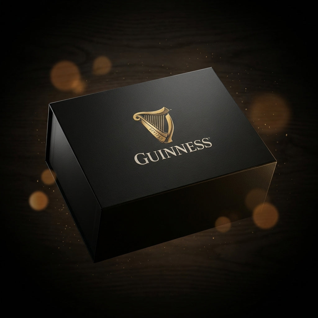 A black Guinness Gift Box - Large featuring a gold harp logo and the word “GUINNESS” printed on the lid.