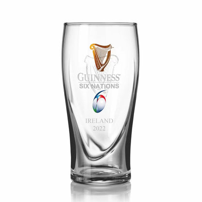 The Guinness Six Nations Pint Glass - 4 Pack from Guinness Webstore US features the Guinness logo, Six Nations rugby emblem, and "Ireland 2022"—ideal for any rugby fan’s matchday celebration.