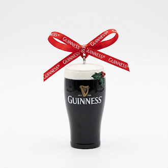 Add a touch of festive cheer and classic pub style to your holiday décor with the Guinness Christmas Pint Decoration. This resin ornament, shaped like a pint and featuring a holly accent with a red ribbon labeled “Guinness” tied in a bow on top, is the perfect addition to any collection of Christmas decorations.