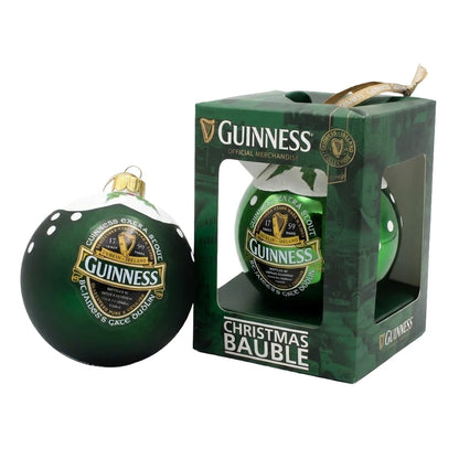 A Green Collection Gloss Bauble from Guinness is displayed beside its packaging, which features the Guinness logo, “Christmas Bauble” text on the front, and classic Guinness Ireland design elements.
